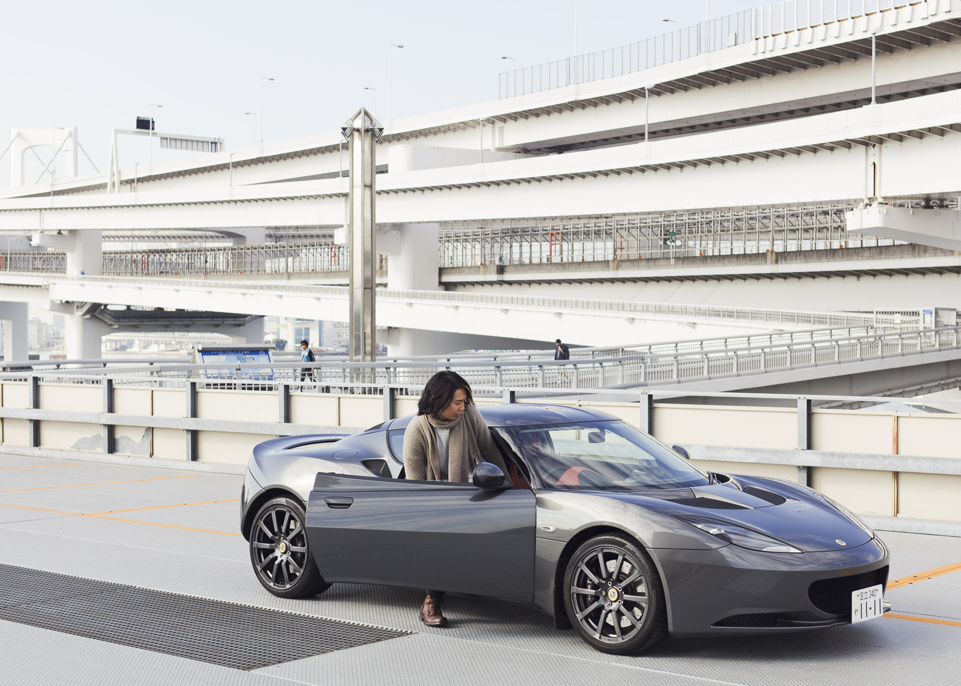 Junichi Suwabe with a Lotus car in Tokyo